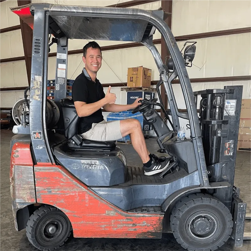 A team member operating a forklift